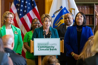 A photo of Governor Maura Healey. Lt. Governor Kim Driscoll, Chrystal Kornegay and others at the announcement of the Massachusetts Community Climate Bank on June 13, 2023